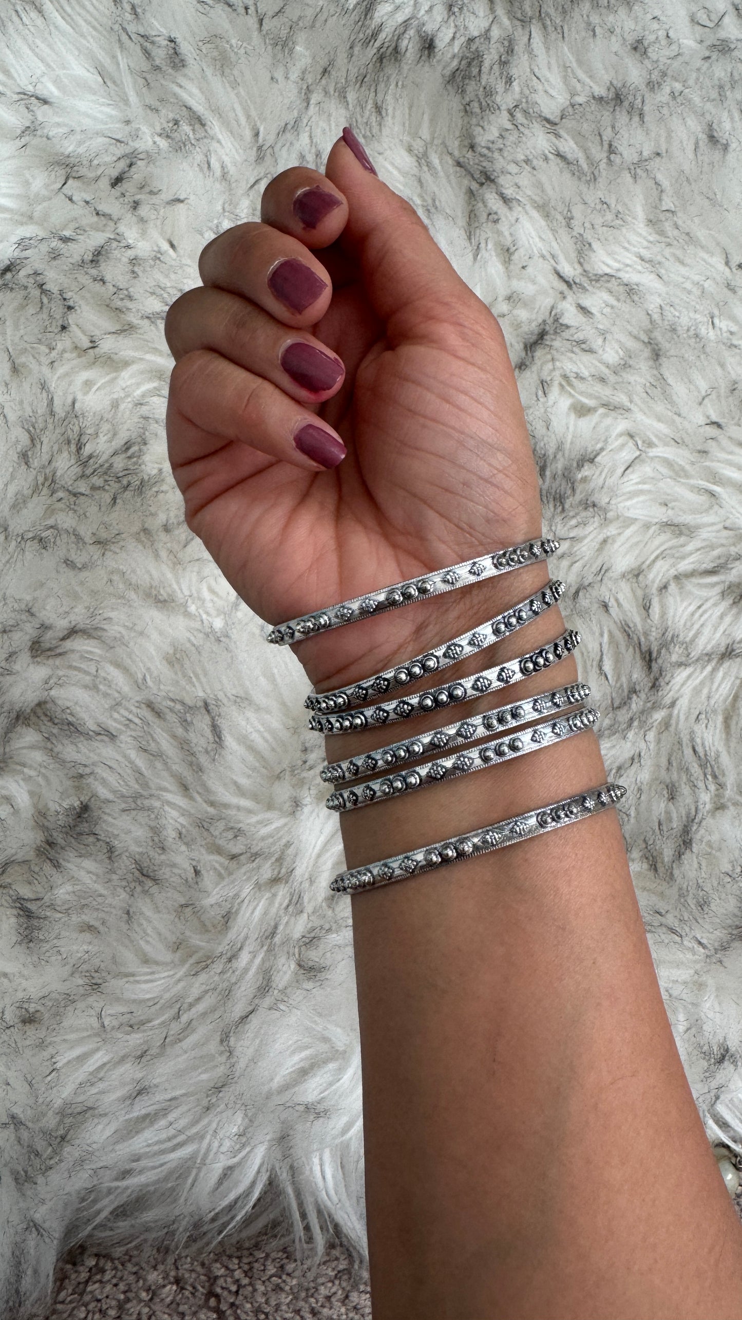 C. Silver Bangles