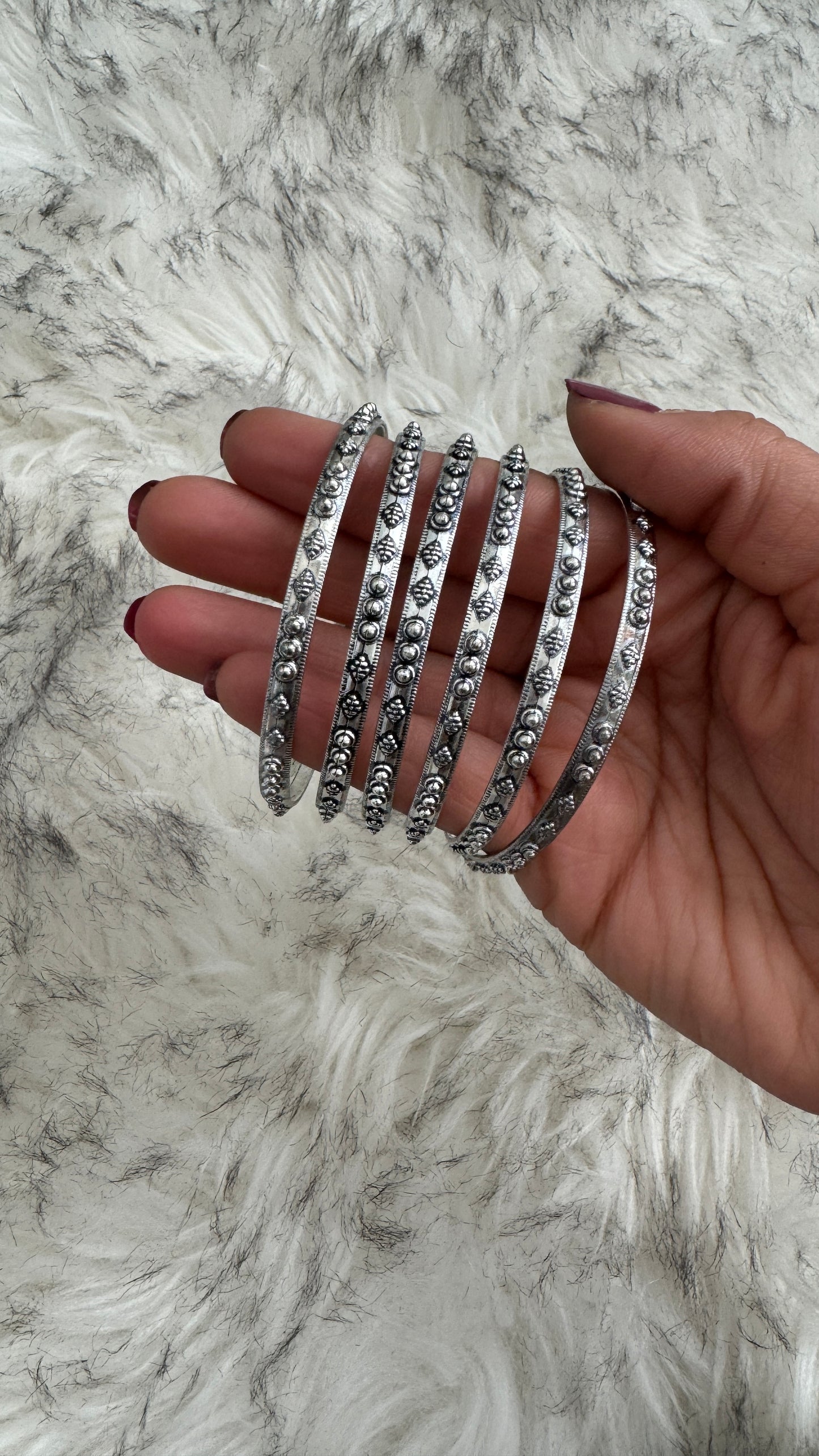 C. Silver Bangles
