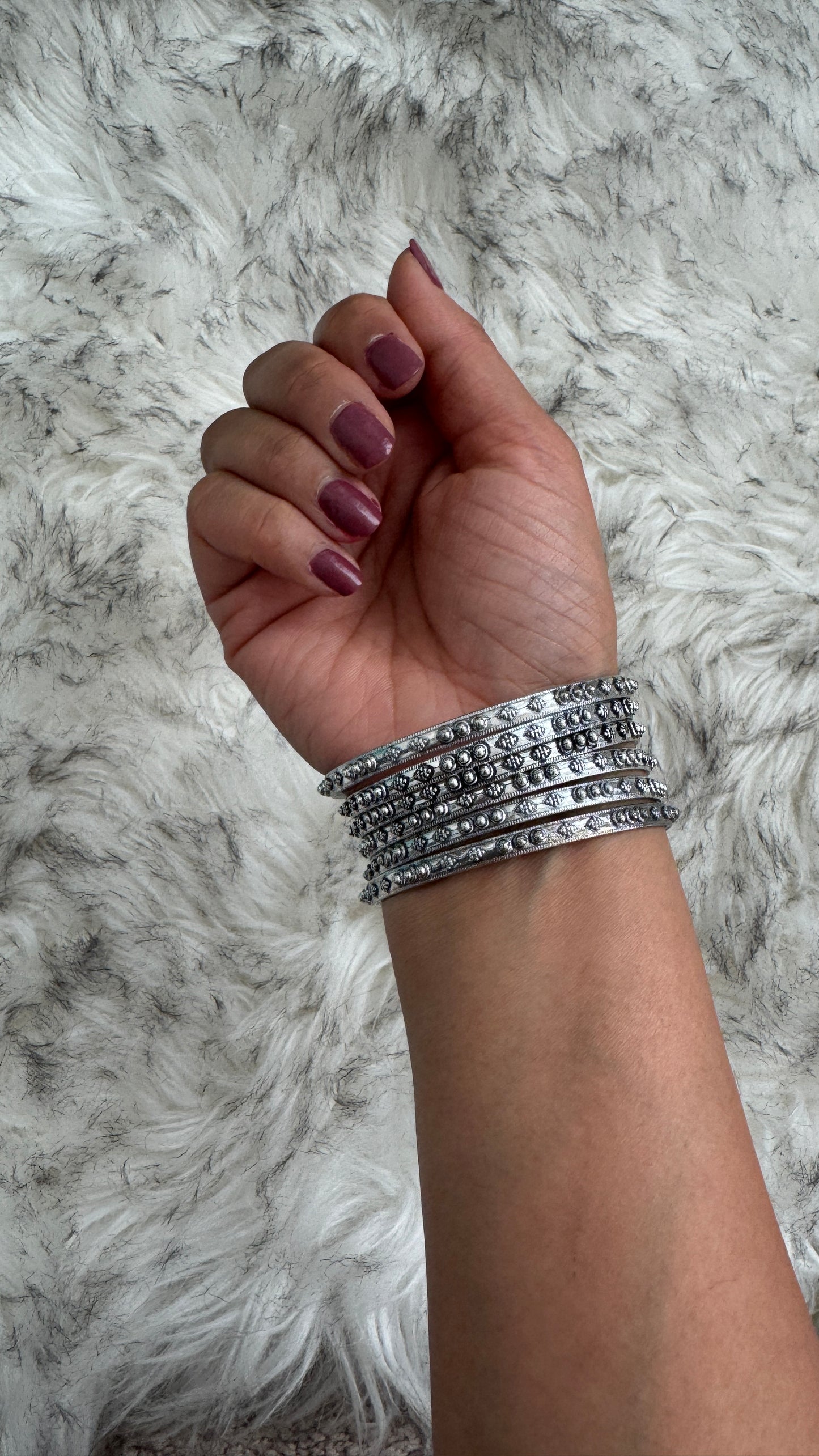 C. Silver Bangles